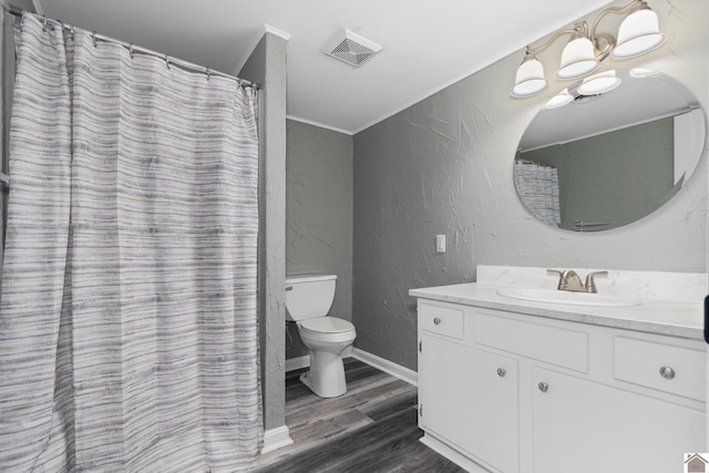 bathroom with vanity, hardwood / wood-style flooring, toilet, and ornamental molding