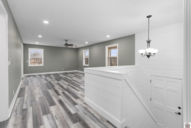 hall featuring hardwood / wood-style floors and an inviting chandelier