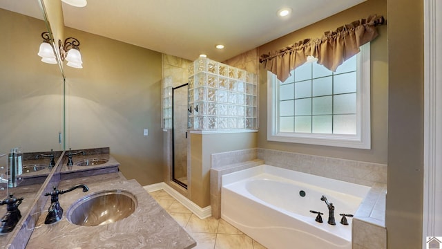 bathroom with tile patterned flooring, vanity, and separate shower and tub