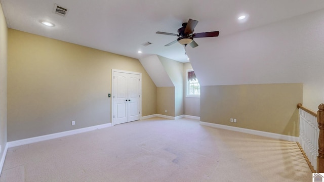 additional living space with light colored carpet, vaulted ceiling, and ceiling fan