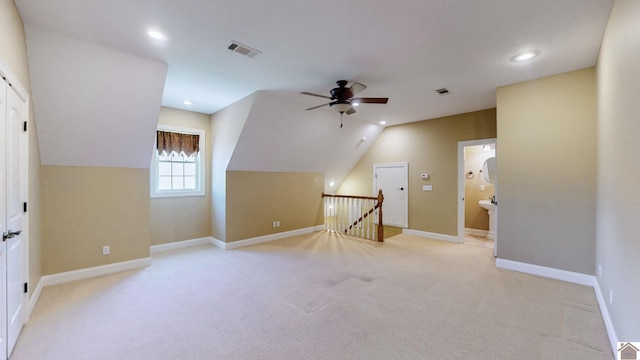 bonus room with ceiling fan, light colored carpet, and lofted ceiling