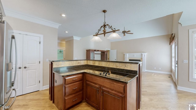 kitchen featuring decorative light fixtures, stainless steel fridge, light hardwood / wood-style floors, and crown molding