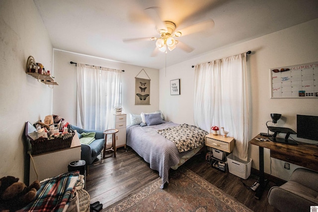 bedroom with ceiling fan and dark hardwood / wood-style flooring