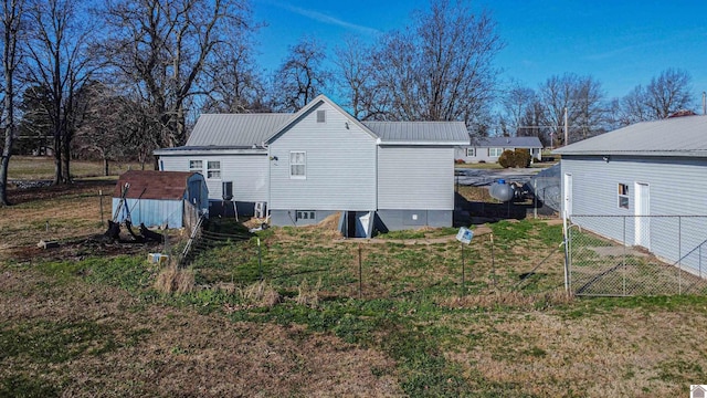 view of side of home with a shed