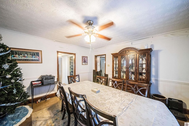 dining space with ceiling fan and a textured ceiling