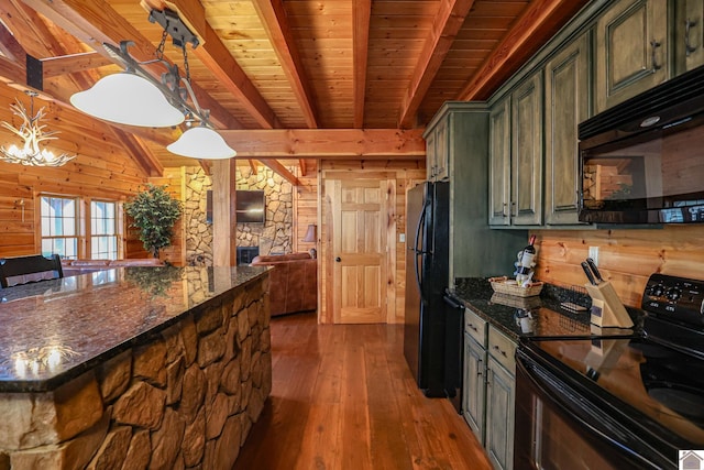 kitchen with black appliances, decorative light fixtures, beam ceiling, and wood-type flooring