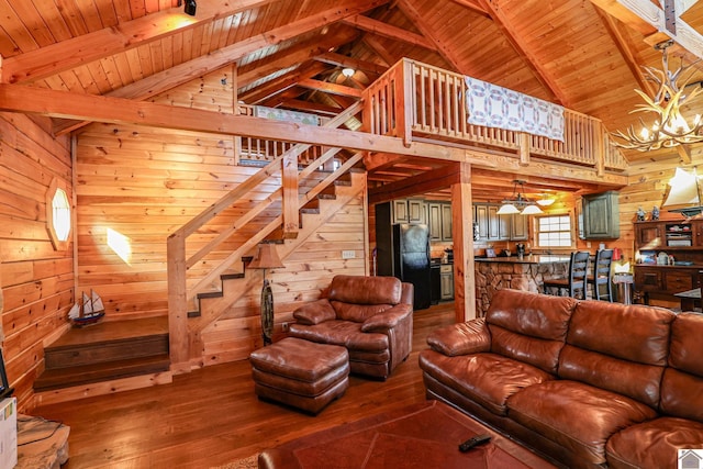 living room featuring beam ceiling, wooden walls, wood ceiling, and hardwood / wood-style flooring