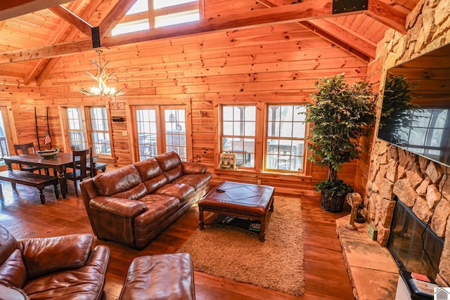 living room featuring hardwood / wood-style flooring, beam ceiling, and high vaulted ceiling