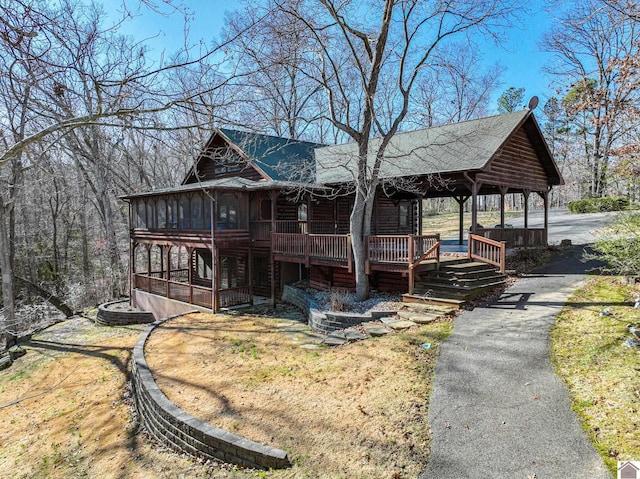 view of front of property featuring a sunroom and covered porch