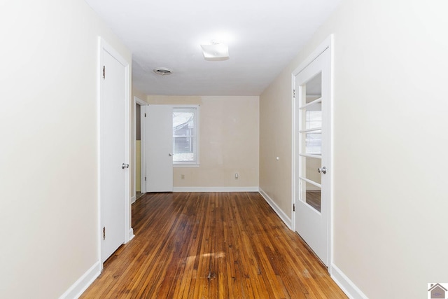 hallway with hardwood / wood-style flooring