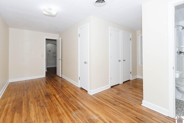 spare room featuring wood-type flooring