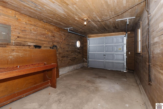 garage featuring electric panel, wooden walls, and wood ceiling