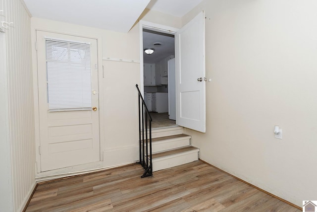 stairs featuring hardwood / wood-style flooring