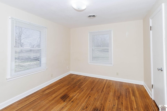 empty room with hardwood / wood-style flooring