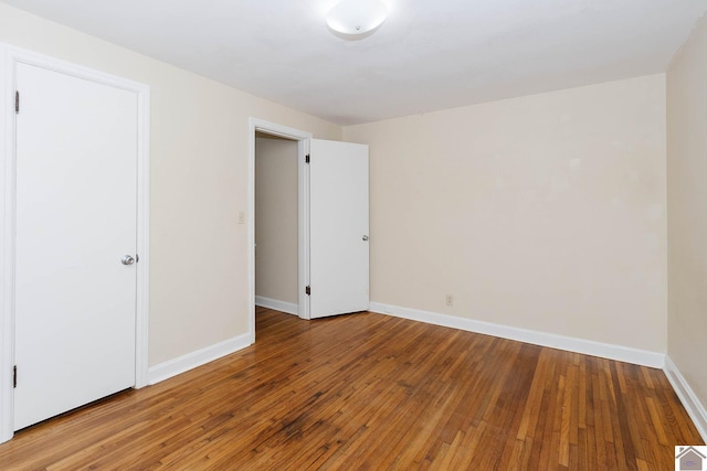 unfurnished room with hardwood / wood-style flooring