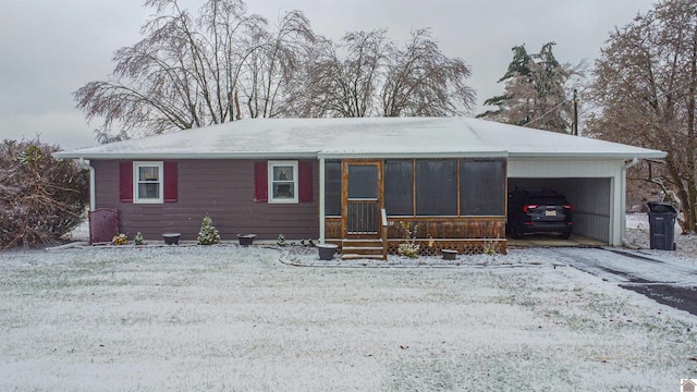 ranch-style house with a carport and a sunroom