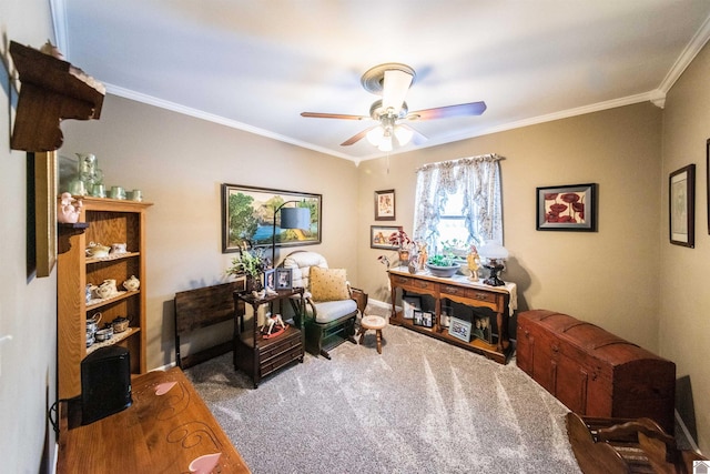 living area with carpet flooring, ceiling fan, and crown molding