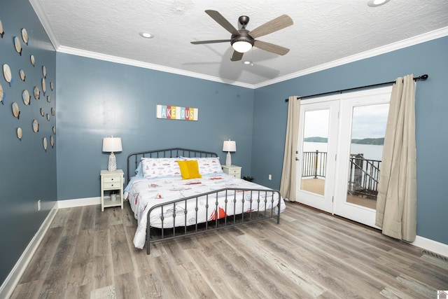 bedroom featuring access to exterior, a textured ceiling, ceiling fan, crown molding, and hardwood / wood-style flooring