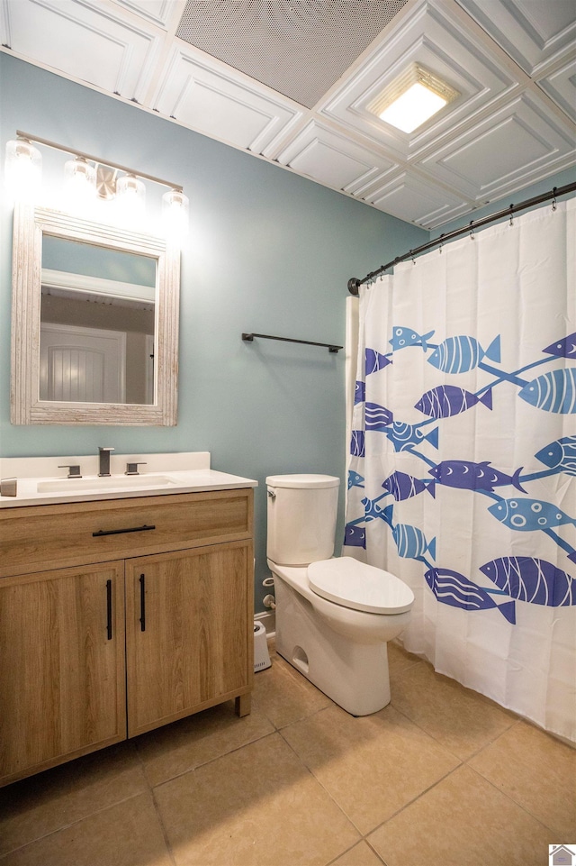 bathroom featuring tile patterned flooring, vanity, and toilet