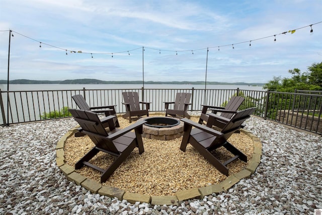 view of patio / terrace with a water view and a fire pit