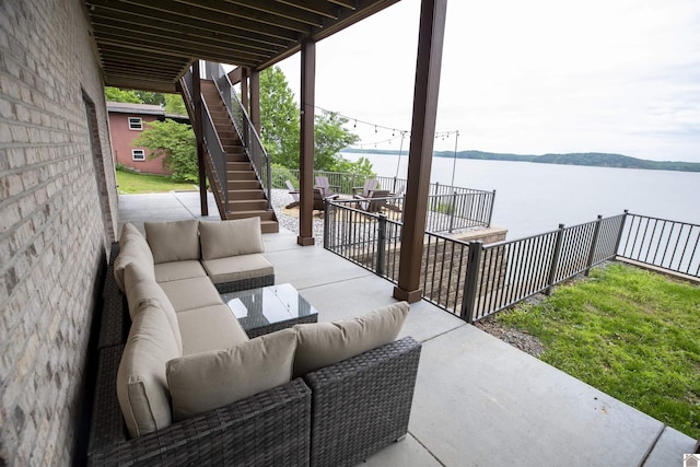 view of patio / terrace with outdoor lounge area and a water view