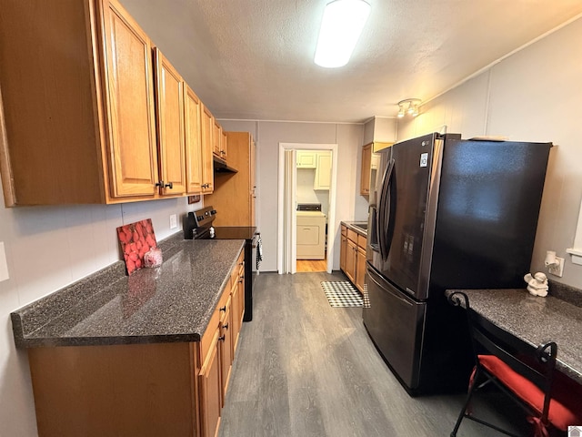 kitchen with stainless steel fridge, dark hardwood / wood-style flooring, a textured ceiling, washer / clothes dryer, and black range with electric stovetop