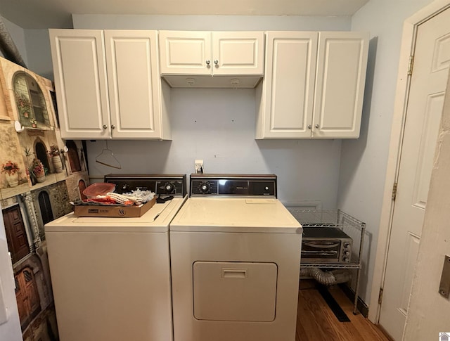 laundry room with dark hardwood / wood-style floors, cabinets, and independent washer and dryer