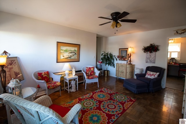 living room featuring dark parquet flooring and ceiling fan