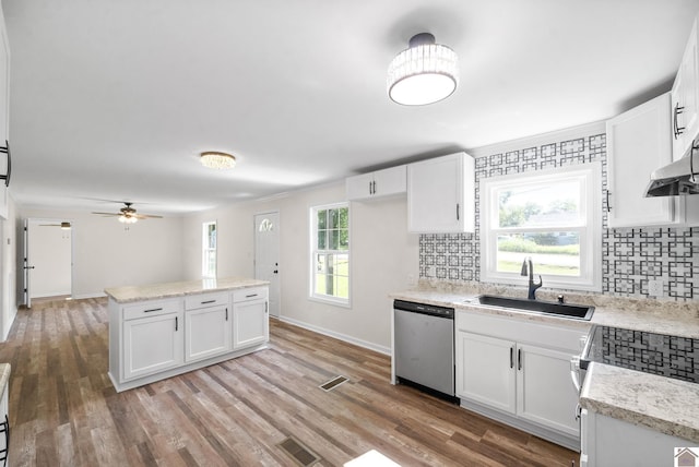 kitchen with dishwasher, tasteful backsplash, white cabinetry, and sink