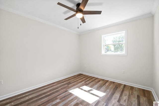 empty room featuring ceiling fan, crown molding, and dark wood-type flooring