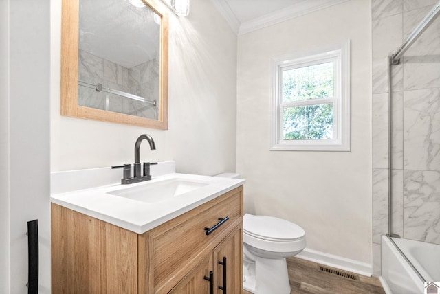 full bathroom featuring ornamental molding, bath / shower combo with glass door, vanity, hardwood / wood-style flooring, and toilet