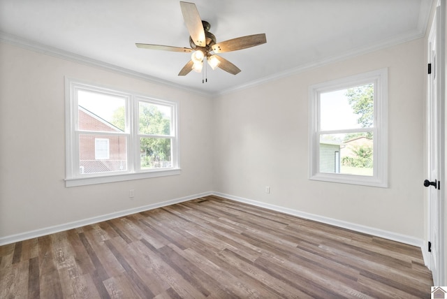 spare room with wood-type flooring, ceiling fan, and crown molding