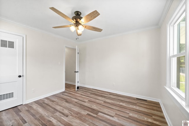 unfurnished room featuring light hardwood / wood-style floors, ceiling fan, and ornamental molding