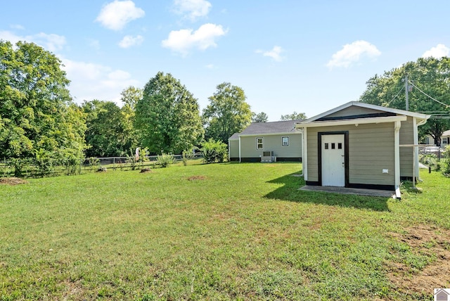 view of yard with cooling unit and a shed