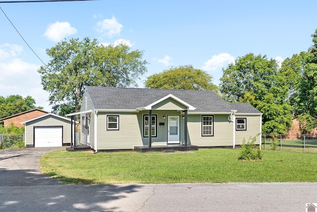 view of front of property with a front yard, a porch, a garage, and an outdoor structure