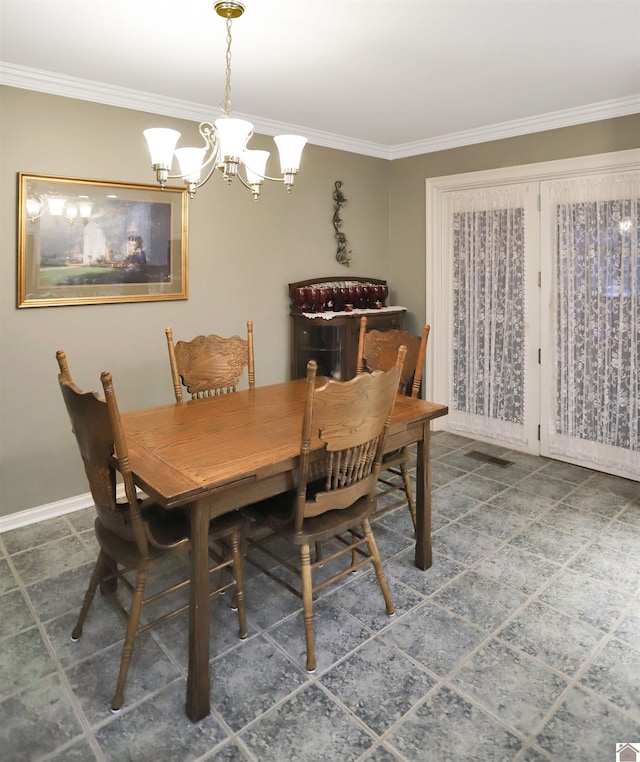 dining area with ornamental molding and a notable chandelier