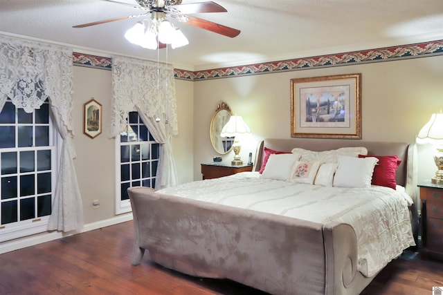 bedroom featuring a textured ceiling, ceiling fan, crown molding, and dark hardwood / wood-style floors