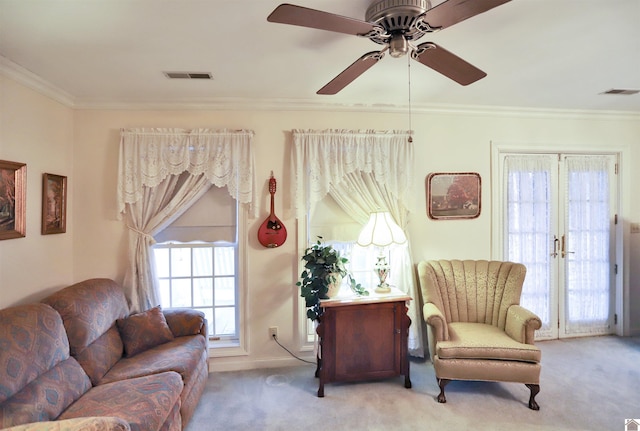 living room featuring ceiling fan, crown molding, light carpet, and french doors