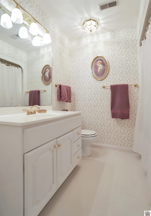 bathroom with toilet and vanity