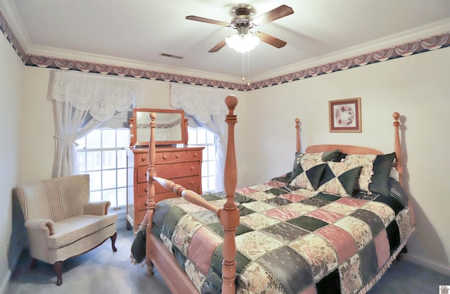 carpeted bedroom with ceiling fan and ornamental molding