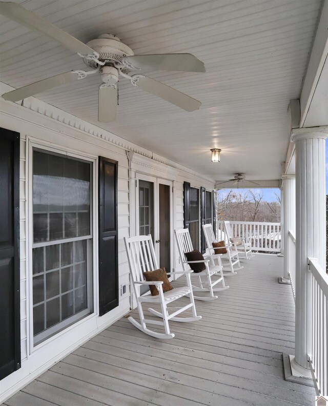 wooden terrace with ceiling fan and a porch