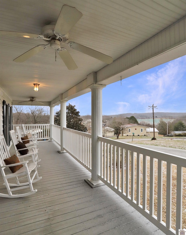 deck with covered porch and ceiling fan