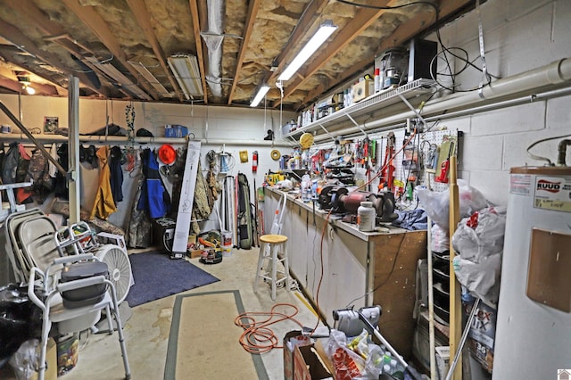 basement featuring electric water heater and a workshop area