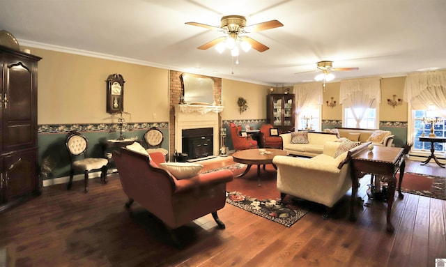 living room with ceiling fan, a large fireplace, crown molding, and hardwood / wood-style floors