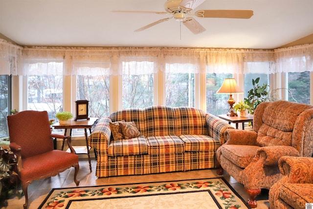 living room featuring ceiling fan and a wealth of natural light