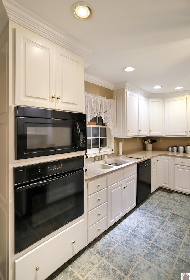 kitchen with sink, white cabinets, black appliances, and crown molding