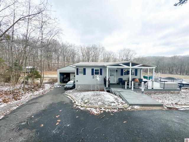 view of front of property featuring a deck and a carport