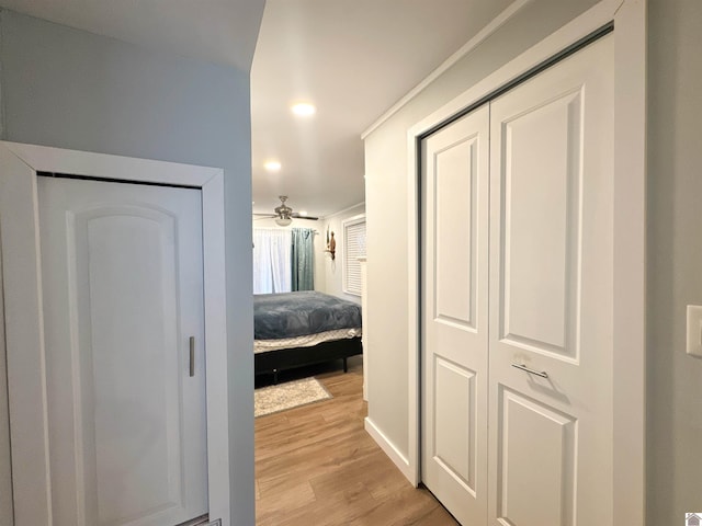 hallway with light hardwood / wood-style floors