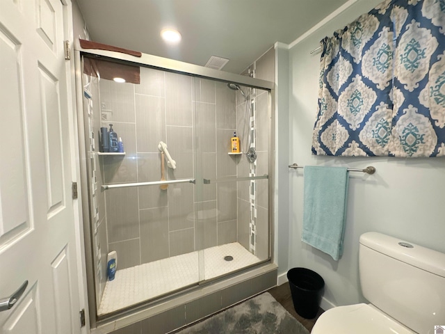 bathroom featuring an enclosed shower and toilet