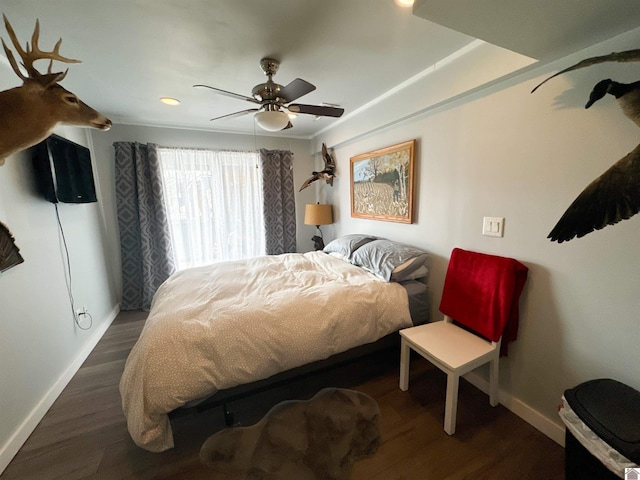 bedroom with ceiling fan and dark hardwood / wood-style floors